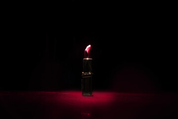 One lipsticks on dark background. Mock up, template or poster for advertising lipstick. Concept of...