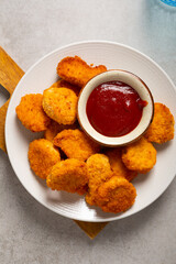 Overhead view of crisp nuggets on plate fast food and ketchup sauce