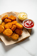 Close up of crisp nuggets on plate fast food and sauce