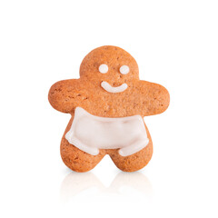 Single homemade sweet gingerbread cookie or biscuit in shape of smiling man with sugar icing isolated on white background with reflection baked for christmas of new year holidays celebration as snack