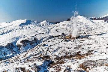 Aerial view to geothermal power plant in mountain. Clean green renewable energy in Kamchatka. - 550835651