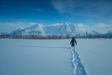 Walking in heavy snow towards  beautiful Ahkka, Stora Sjöfallet National Park, Swedish Lapland