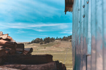 Stacks of Firewood. Preparation of firewood for the winter. Background landscape of the Andes