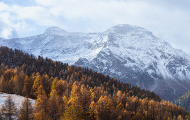 The landscape of Alpe Devero, with the colors of autumn, the first snow and breathtaking views, near the village of Baceno, Italy - November 2022.