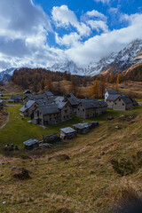 The landscape of Alpe Devero, with the colors of autumn, the first snow and breathtaking views, near the village of Baceno, Italy - November 2022.