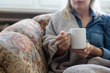 warm cup of hot coffee warming in the hands of a girl.