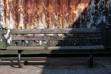 bench in front of rusty background