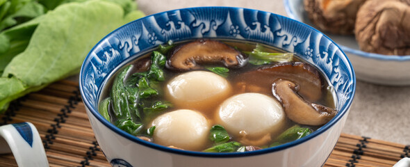 Eating big tangyuan yuanxiao with savory soup in Taiwan.