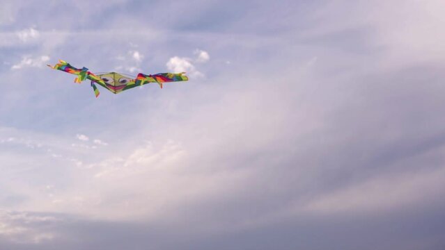 A multi-colored kite against the sky.