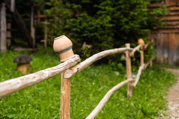 Old wooden farmhouse fence with jugs