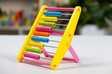 Colorful children's abacus on the table. Mathematics, arithmetic for preschool and school children, learning to count