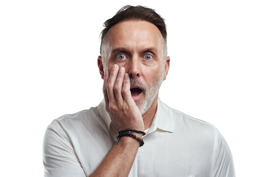 PNG studio portrait of a mature man looking surprised against a grey background