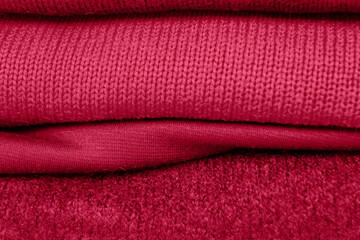 Luxurious cloth background of velvet, velor fabric in trendy color Viva magenta. Concept poster of color of the year 2023.