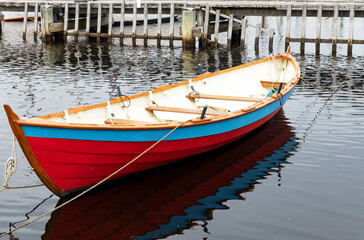 wooden clinker boat moored at the jetty.