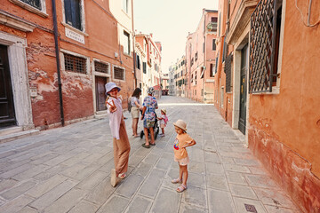 Family tourist in Venice, Italy at Piscina Samuele street.