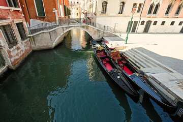 Fototapeta na wymiar Canal with two gondolas in Venice, Italy.
