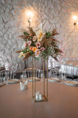Boho wedding decor. Wedding centerpieces arrangements with dried flowers floristry and candles, boho style.
