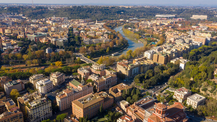 Aerial view over the Tiber River near Prati district in Rome, Italy. Autumn colors dye the trees along the river.