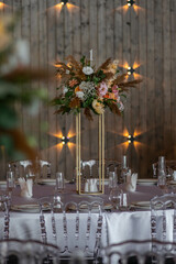 Boho wedding decor. Wedding centerpieces arrangements with dried flowers floristry and candles, boho style.