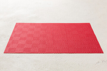 Perspective view of red tablecloth for food on cement background. Empty space for your design