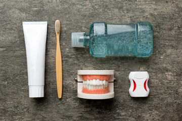 Mouthwash and other oral hygiene products on colored table top view with copy space. Flat lay. Dental hygiene. Oral care kit. Dentist concept
