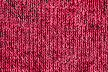 Red viva magenta knitted texture. Handmade Knitwear. Color of the year 2023 toned. Background