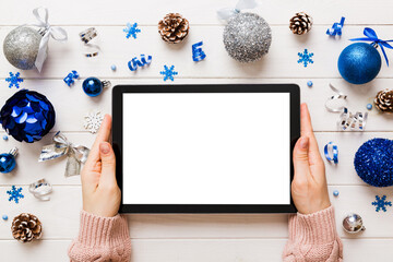Christmas online shopping from home, female hands holding tablet pc with blank white display top...