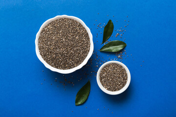 Chia seeds in bowl on colored background. Healthy Salvia hispanica in small bowl. Healthy superfood