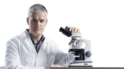 Medical scientist posing with a microscope