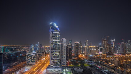 Obraz na płótnie Canvas Panorama showing Dubai's business bay towers aerial night timelapse. Rooftop view of some skyscrapers