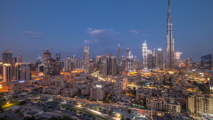 Fototapeta na wymiar Dubai Downtown night to day timelapse with tallest skyscraper and other towers