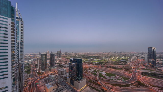 Aerial view of media city and al barsha heights district area day to night timelapse from Dubai marina.