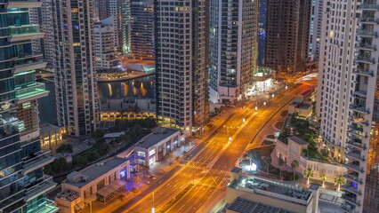 Aerial view on Dubai Marina skyscrapers and the most luxury yacht in harbor night to day timelapse, Dubai, United Arab Emirates