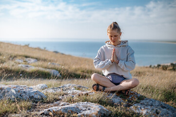 Girl practice yoga meditation outdoor in park