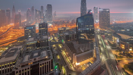 Fototapeta na wymiar Futuristic Dubai Downtown and finansial district skyline aerial night to day timelapse.