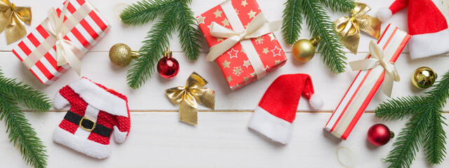 Christmas decorations and fir tree branch and gift boxon dark table. Top view frame with copy space