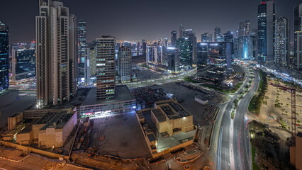 Panorama showing Bay Avenue with modern towers residential development in Business Bay aerial night timelapse, Dubai