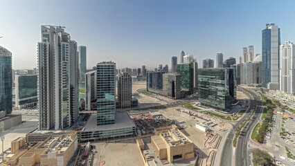 Naklejka na ściany i meble Panorama showing Bay Avenue with modern towers residential development in Business Bay aerial timelapse, Dubai