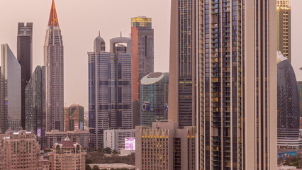 Fototapeta na wymiar Row of the tall buildings around Sheikh Zayed Road and DIFC district aerial day to night timelapse in Dubai