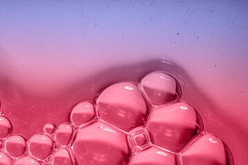 Magenta and purple liquid background with bubbles. Top view. Change color of the year theme. 