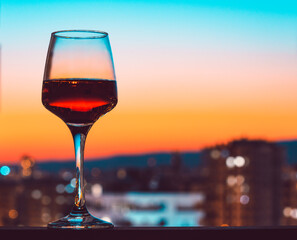 Glass of wine on the city night background	