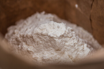 White flour in a paper bag, close up
