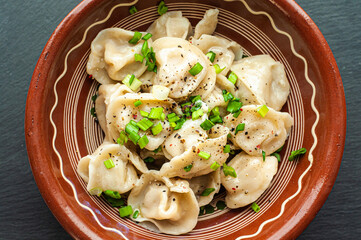 a classic traditional dish of dumplings with meat, butter, pepper and greens, food of the countries of the world, gastrotourism