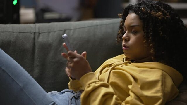 One upset black girl angry at message. African American reacting negatively to notification