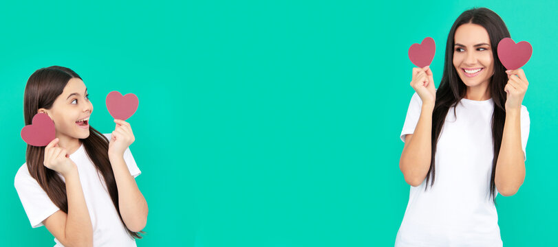 Mother and daughter child banner, copy space, isolated background. celebrating valentines day. child with mom. heart symbol of love. mother and daughter hold heart.