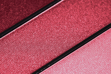 Palette of eyeshadows in viva magenta tones. Close-up of a make-up product. Top view. Selective focus. Color trend year 2023.