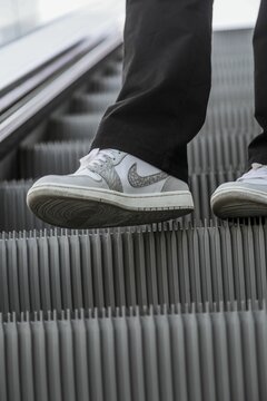 Person's foot wearing air Jordan 1 low PRM