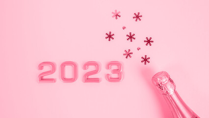 Numbers 2023  and bottle of champagne with confetti. New Years celebration or party.