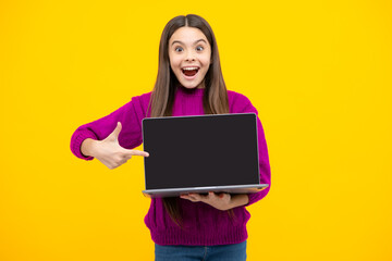 Fototapeta premium Teenager school girl hold notebook laptop. School children on isolated studio background. Screen of laptop computer with copyspace mockup.