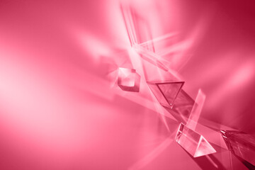 Glass prisms and cubes with spectrum rays on magenta backdrop. Abstract background with reflection and refraction of light.Color of the 2023 Year.
